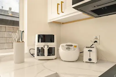 a kitchen with several appliances sitting on a counter at Lyn's Stay in Westminster