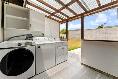 an outdoor kitchen with a washer and dryer in a kitchen at Lyn's Stay in Westminster