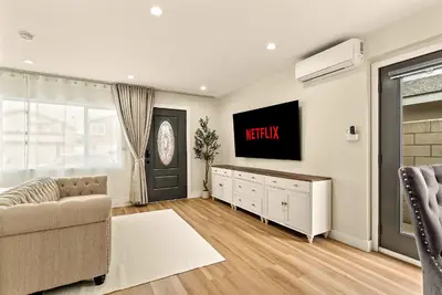 a living room with a television and a couch at Lyn's Stay in Westminster