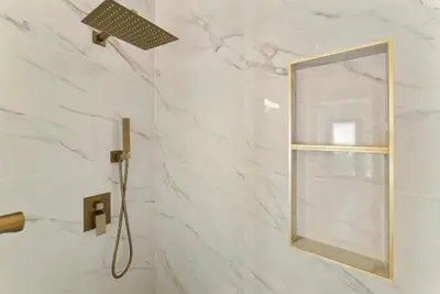 a bathroom with a shower with a mirror at Lyn's Stay in Westminster
