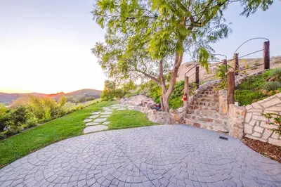 a driveway with a stone path and a tree at Mintcello Estate in Malibu