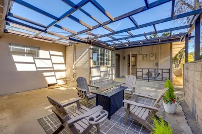 a patio with chairs and a table with a glass roof at Walkable Home Base Near LLUMC and Campus! in Loma Linda