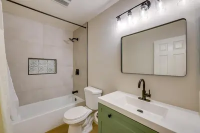 a bathroom with a white toilet and a sink at Walkable Home Base Near LLUMC and Campus! in Loma Linda