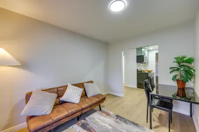 a living room with a couch and a table at 1 Mi to LLUMC! Loma Linda Home with Shared Patio in Loma Linda
