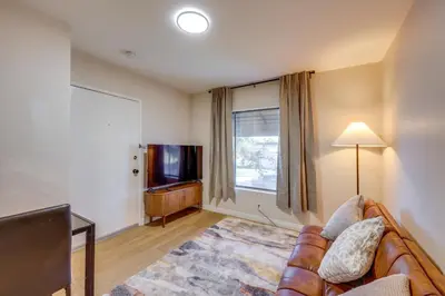 a living room with a couch and a flat screen tv at 1 Mi to LLUMC! Loma Linda Home with Shared Patio in Loma Linda