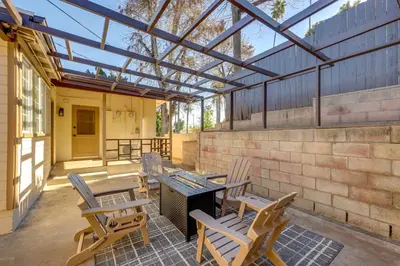 a patio with chairs and a table and a glass roof at 1 Mi to LLUMC! Loma Linda Home with Shared Patio in Loma Linda