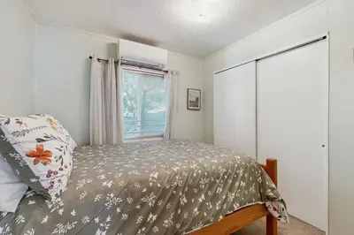 a bedroom with a bed and a window at Lakeview Cabin in Crestline
