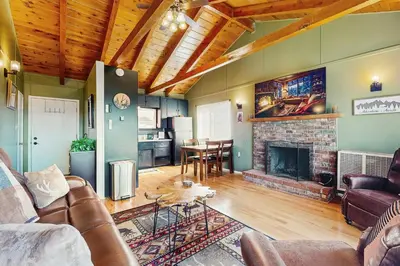 a living room with a couch and a fireplace at Lakeview Cabin in Crestline