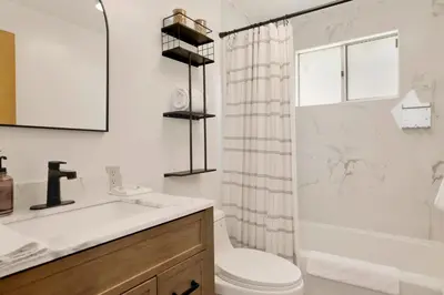 a bathroom with a sink and a toilet and a shower at Sweet Dream Cabin on Dream Street | Walk to Alpine Slide, Dining, & Big Bear Fun in Big Bear Lake