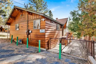 a cabin with a sign on the side of it at Sweet Dream Cabin on Dream Street | Walk to Alpine Slide, Dining, & Big Bear Fun in Big Bear Lake