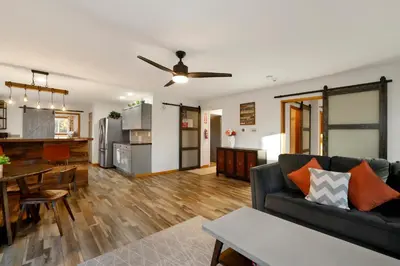a living room and kitchen with a couch and a table at The Highland Getaway at Big Bear Village | Downtown Modern Retreat Cottage in Big Bear Lake