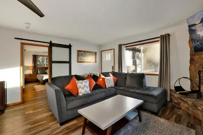 a living room with a couch and a table at The Highland Getaway at Big Bear Village | Downtown Modern Retreat Cottage in Big Bear Lake