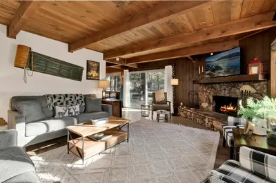 a living room with a couch and a fireplace at Willow Bear Lodge: Shuttle Stop Pet-Friendly, Walk to the Lake | Book Your Big Bear Stay! in Big Bear Lake