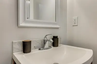 a white sink in a bathroom with a mirror at 5 Mi to Santa Monica Pier and Beach Chic Studio in Los Angeles