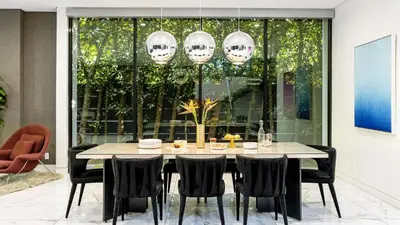 a dining room with a table and black chairs at Private LA Retreat w Pool Hot Tub Fire Pit Near Melrose Ave The Martel House by AvantStay in Los Angeles