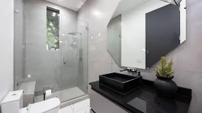 a bathroom with a toilet and a sink and a shower at Private LA Retreat w Pool Hot Tub Fire Pit Near Melrose Ave The Martel House by AvantStay in Los Angeles