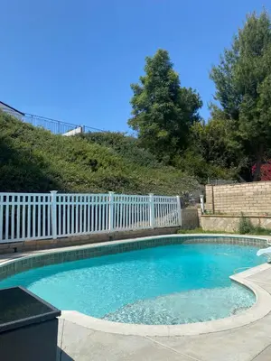 a small swimming pool with a white fence at 530 sq ft Mini House in Walnut in Walnut