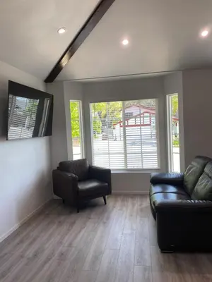 a living room with a couch and two chairs at 530 sq ft Mini House in Walnut in Walnut