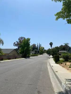 an empty street in a residential neighborhood with trees at 530 sq ft Mini House in Walnut in Walnut