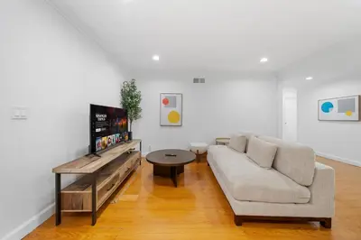a living room with a couch and a flat screen tv at Marbella Lane - Serene & Spacious 3BR Haven in West Covina