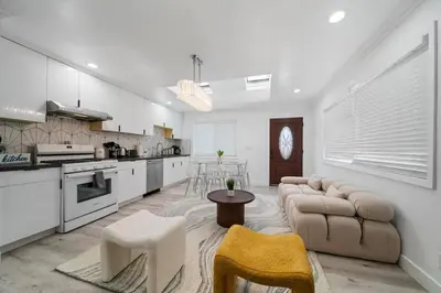 a large living room with a couch and a kitchen at Marbella Lane - Your Cozy Haven 2BR Retreat in West Covina
