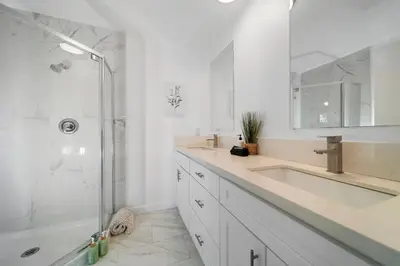 a white bathroom with a sink and a shower at Marbella Lane - Your Cozy Haven 2BR Retreat in West Covina