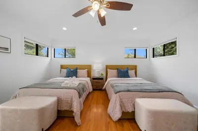 a bedroom with two beds and a ceiling fan at Marbella Lane - Your Cozy Haven 2BR Retreat in West Covina