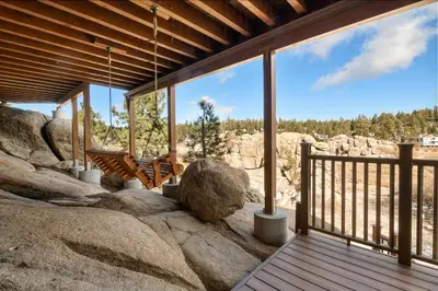 a porch of a house with large rocks at Boulder Cove։ Lakefront Estate in Big Bear Lake