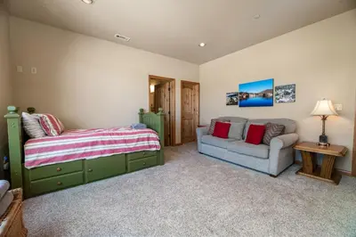 a bedroom with a bed and a couch at Boulder Cove։ Lakefront Estate in Big Bear Lake