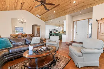 a living room with a couch and chairs and a table at Boulder Cove։ Lakefront Estate in Big Bear Lake
