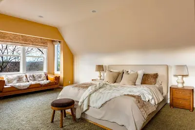 a bedroom with a large bed and a window at Lakeview Mountain Modern in Lake Arrowhead