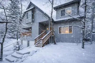 a house in the snow with snow covered trees at The Hidden Pines Mountain Home by Navigate Stays in Running Springs