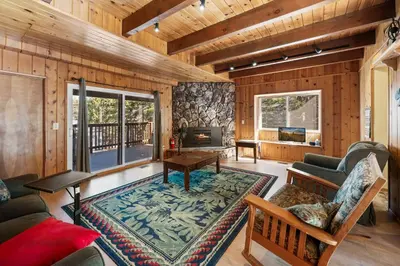 a living room with a couch and a table at The Hidden Pines Mountain Home by Navigate Stays in Running Springs