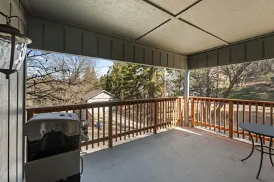a screened in porch with a table and chairs on it at The Hidden Pines Mountain Home by Navigate Stays in Running Springs