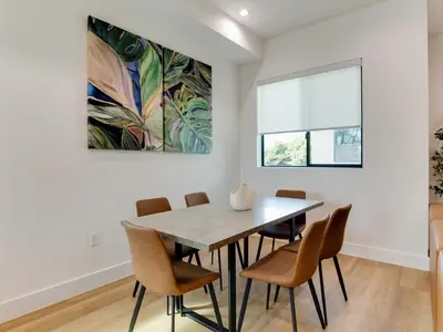 a dining room with a table and chairs at Modern Luxe Retreat Four-Bedroom in Los Angeles