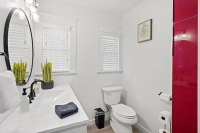 a white bathroom with a sink and a toilet at 1 mile from the Beach Fire Pit, Patio, Parking! in Long Beach