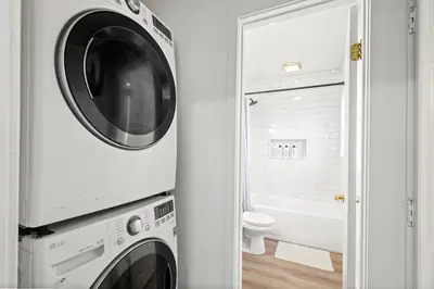 a washer and dryer in a bathroom with a toilet at 1 mile from the Beach Fire Pit, Patio, Parking! in Long Beach