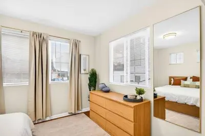 a bedroom with a bed and a dresser and a mirror at Prime Manhattan Beach 2BR Walk to Beach with Parking in Manhattan Beach