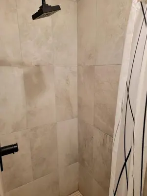 a bathroom with a shower with a glass door at A Tranquil Retreat in Tarzana CA in Tarzana
