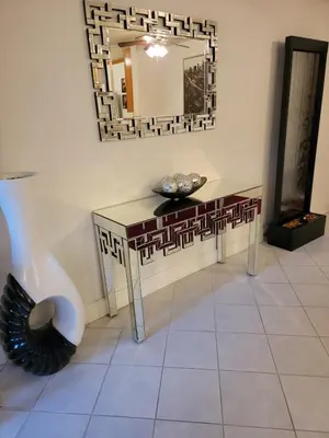 a room with a mirror and a table and a vase at A Tranquil Retreat in Tarzana CA in Tarzana