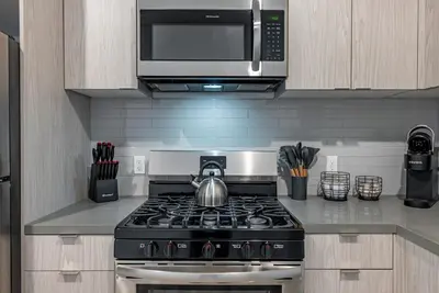 a kitchen with a stove and a microwave at Brand New 2BR Loft near Universal & Hollywood in Los Angeles