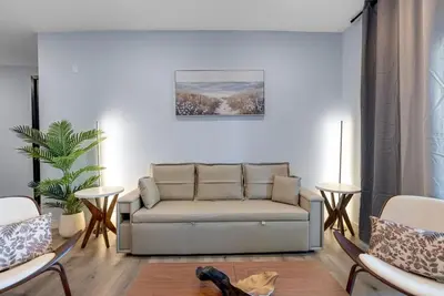 a living room with a couch and two chairs at Brand New 2BR Loft near Universal & Hollywood in Los Angeles