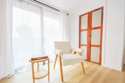 a chair and a table in a room with a window at 2 Units Oasis Villa w terrace&roofdeck 12 pax in Los Angeles