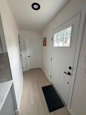 an empty hallway with a door and a window at Welcome To The Modern Casita Riverside! in Riverside
