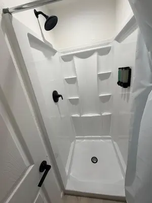 a bathroom with white walls and a ceiling with shelves at Welcome To The Modern Casita Riverside! in Riverside