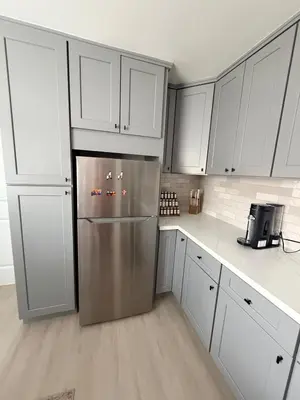 a kitchen with white cabinets and a stainless steel refrigerator at Welcome To The Modern Casita Riverside! in Riverside