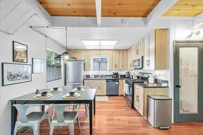 a large kitchen with a table and chairs in it at Arrowbear Retreat - EV Charging, Generator, Arcade in Arrowbear Lake