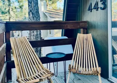 two chairs sitting on the porch of a house at The Highpoint - Close to Lake/Village, Fireplace, Smart TV, Hammock, BBQ in Big Bear Lake