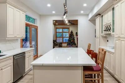 a kitchen with white cabinets and a christmas tree at Games Galore! Pine Mountain Club Retreat Near Town in Pine Mountain Club