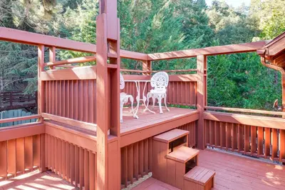 a wooden deck with a table and chairs on it at Games Galore! Pine Mountain Club Retreat Near Town in Pine Mountain Club